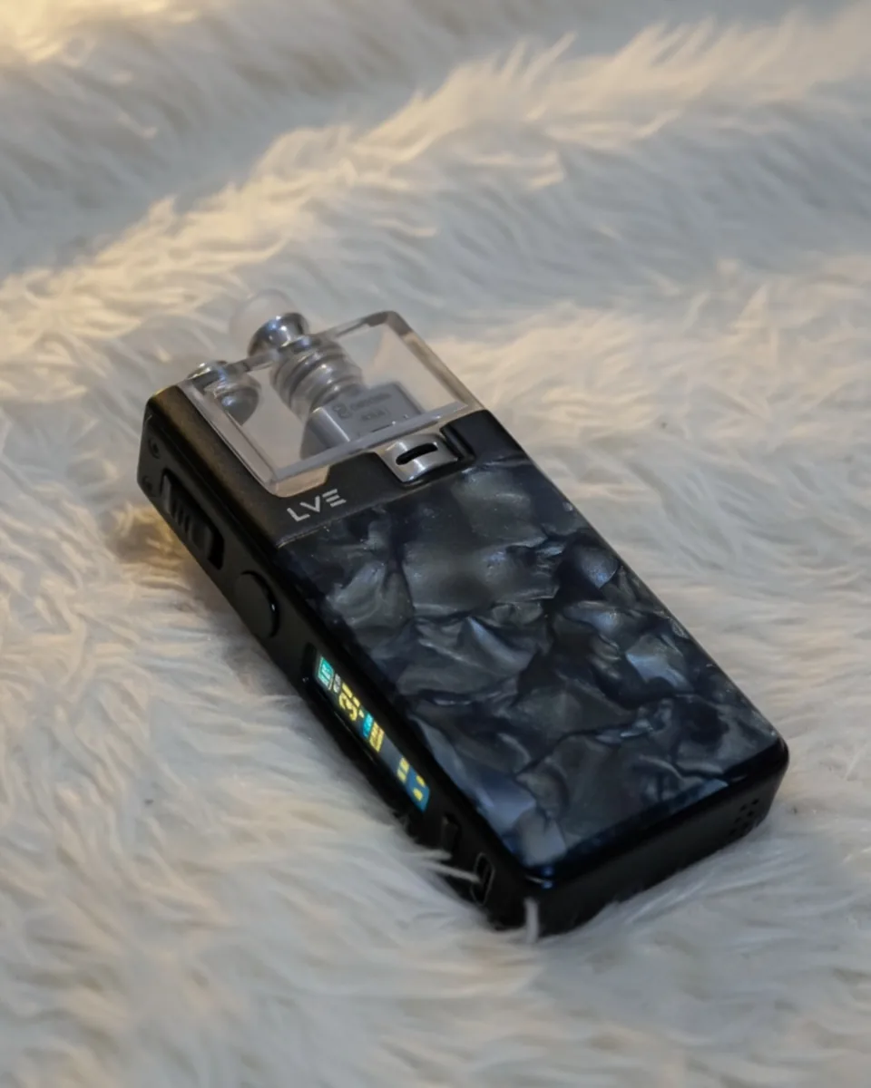 Dark LVE device photographed on a soft light surface